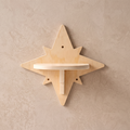 My Kitty City star-shaped solid wood wall-mounted cat climbing step with a natural grain finish on a textured wall.