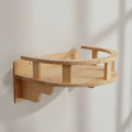My Kitty City wall-mounted wooden cat shelf with a curved railing for resting and climbing in a natural wood finish.